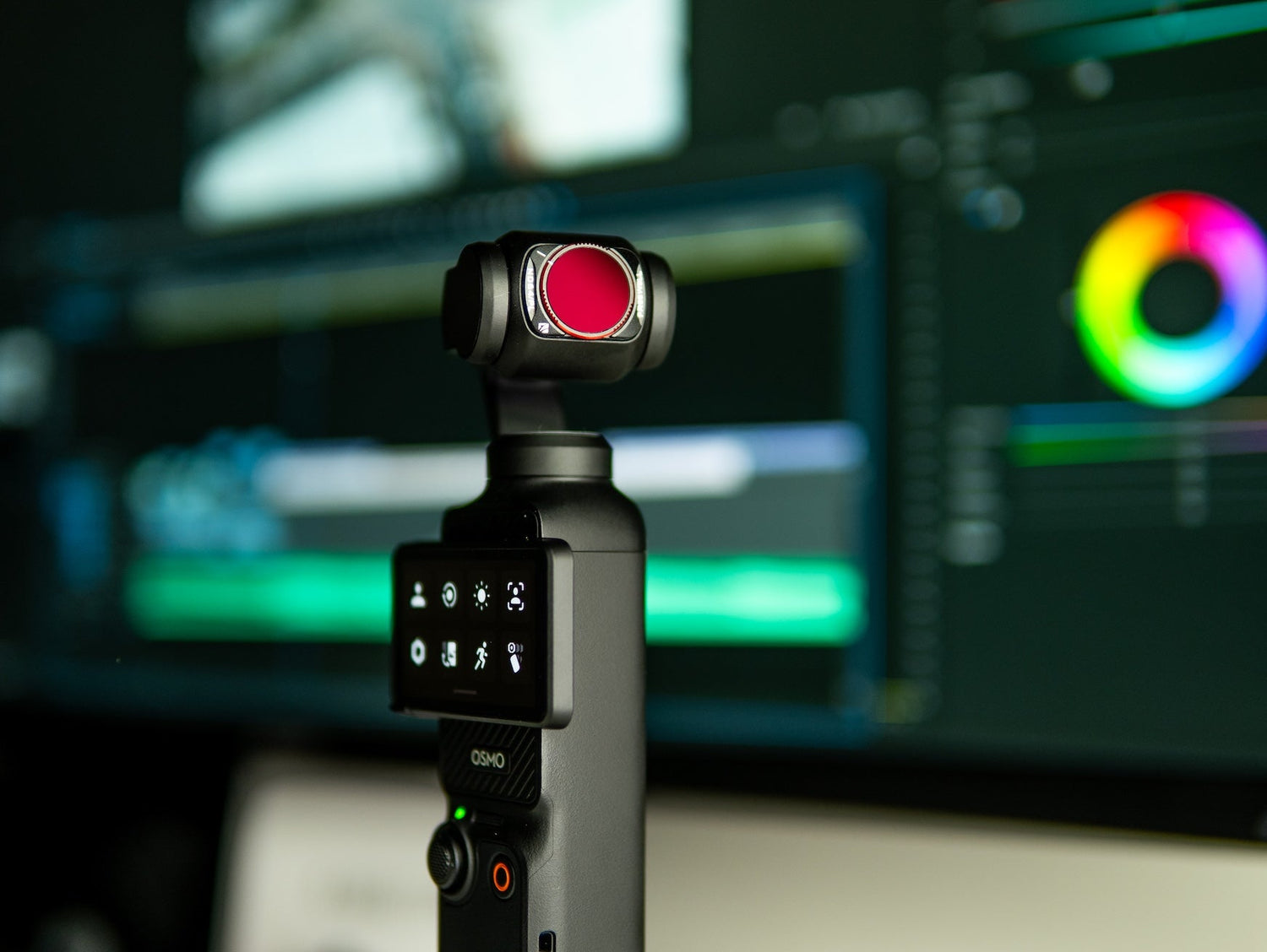DJI Osmo Pocket 3 with mounted Freewell ND filter in front of a color grading and video editing screen.