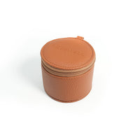 A round, tan leather case with a zipper, embossed with the Freewell logo, designed for carrying Freewell anamorphic, wide angle and 1.7x telephoto lenses.