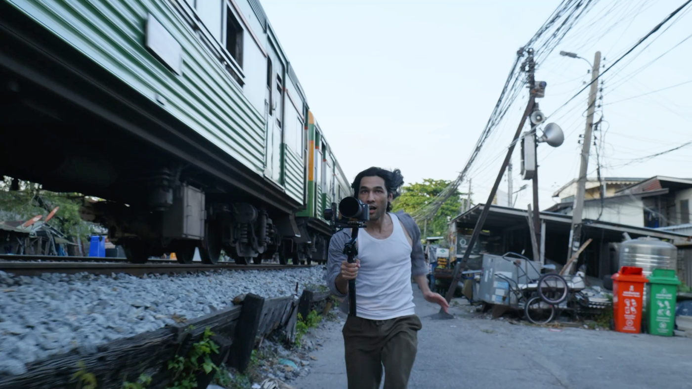 Brandon Li filming beside a moving train with the Freewell VND/CPL system