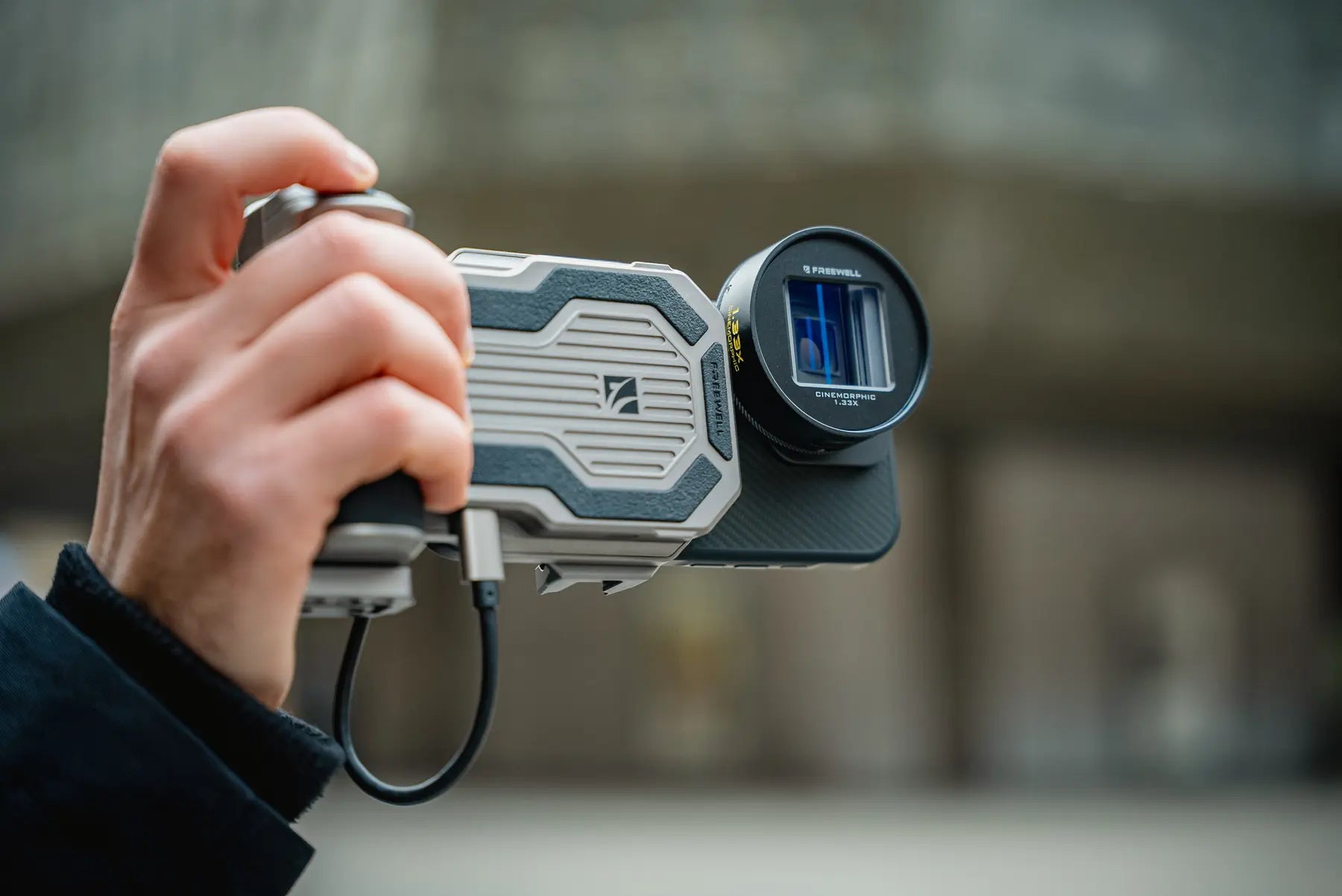 Freewell Pro SSD Hub held in a compact handheld filming setup