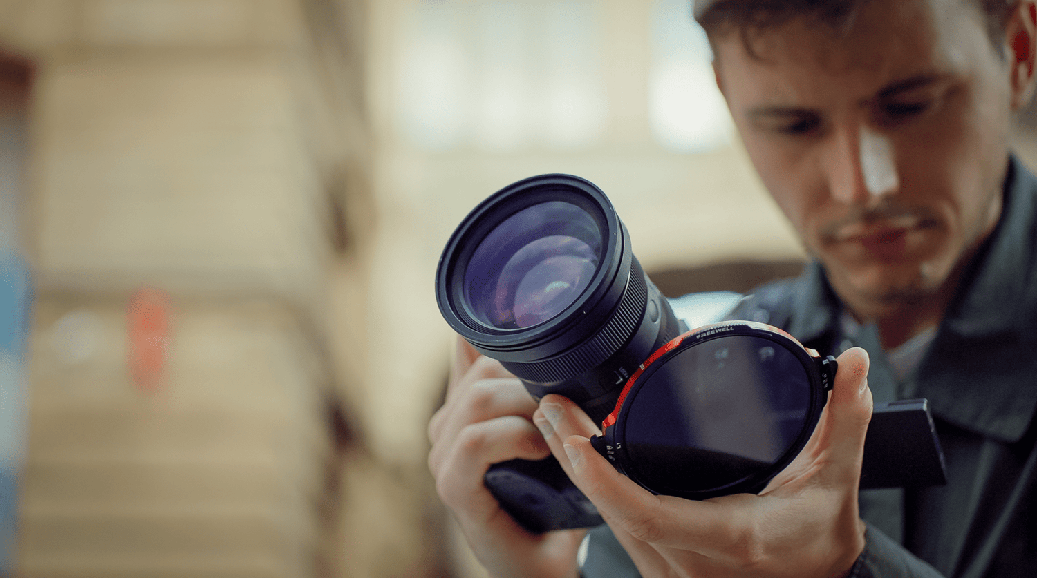 Person examining the Locking VND filter, focusing on the gear in their hand with a slight blur of the background.