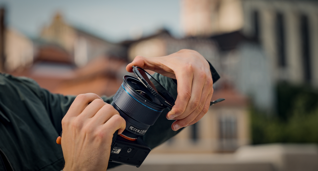 Person adjusting a Locking VND lens with a blurred background