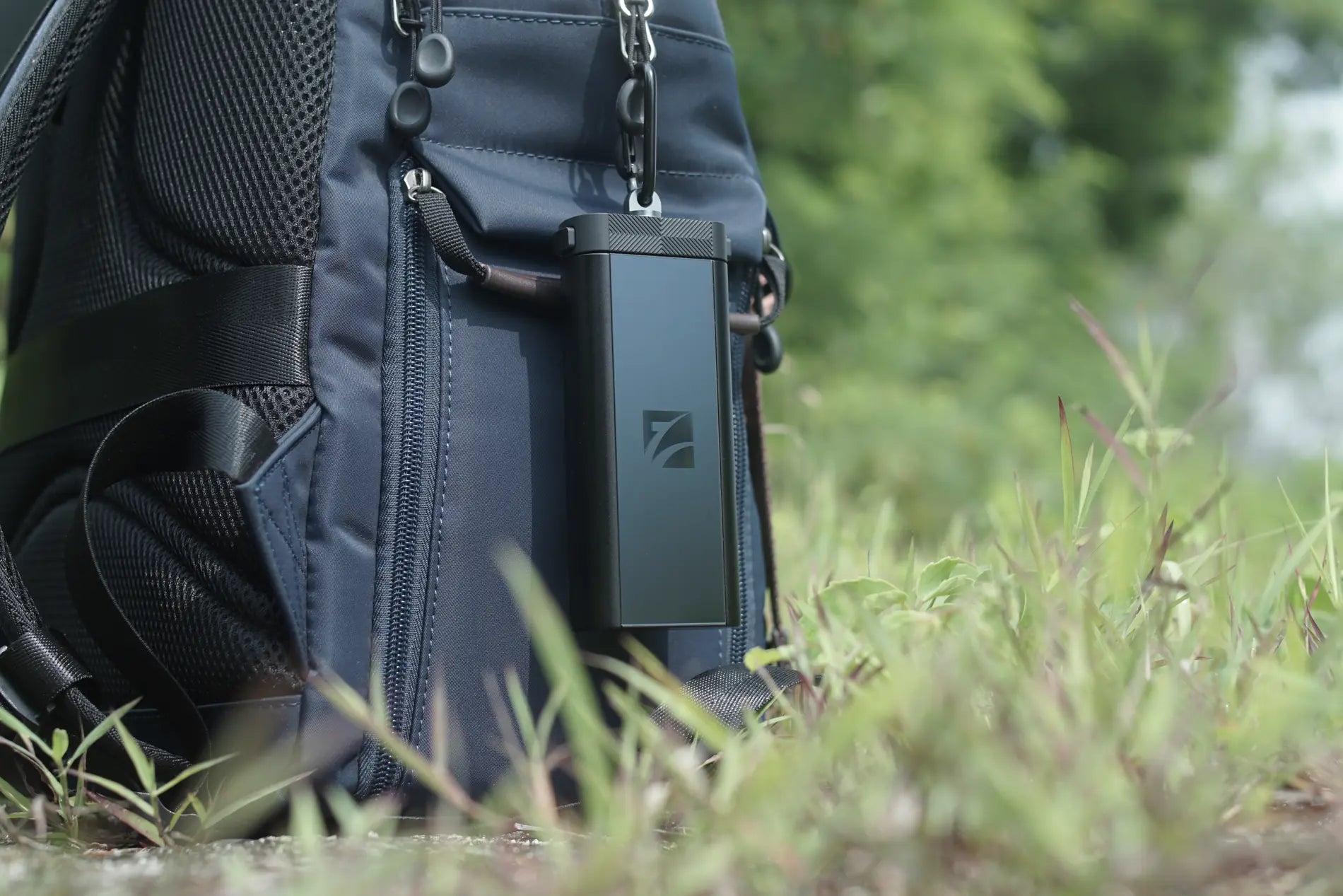 Freewell Duo Reader clipped to a camera backpack outdoors