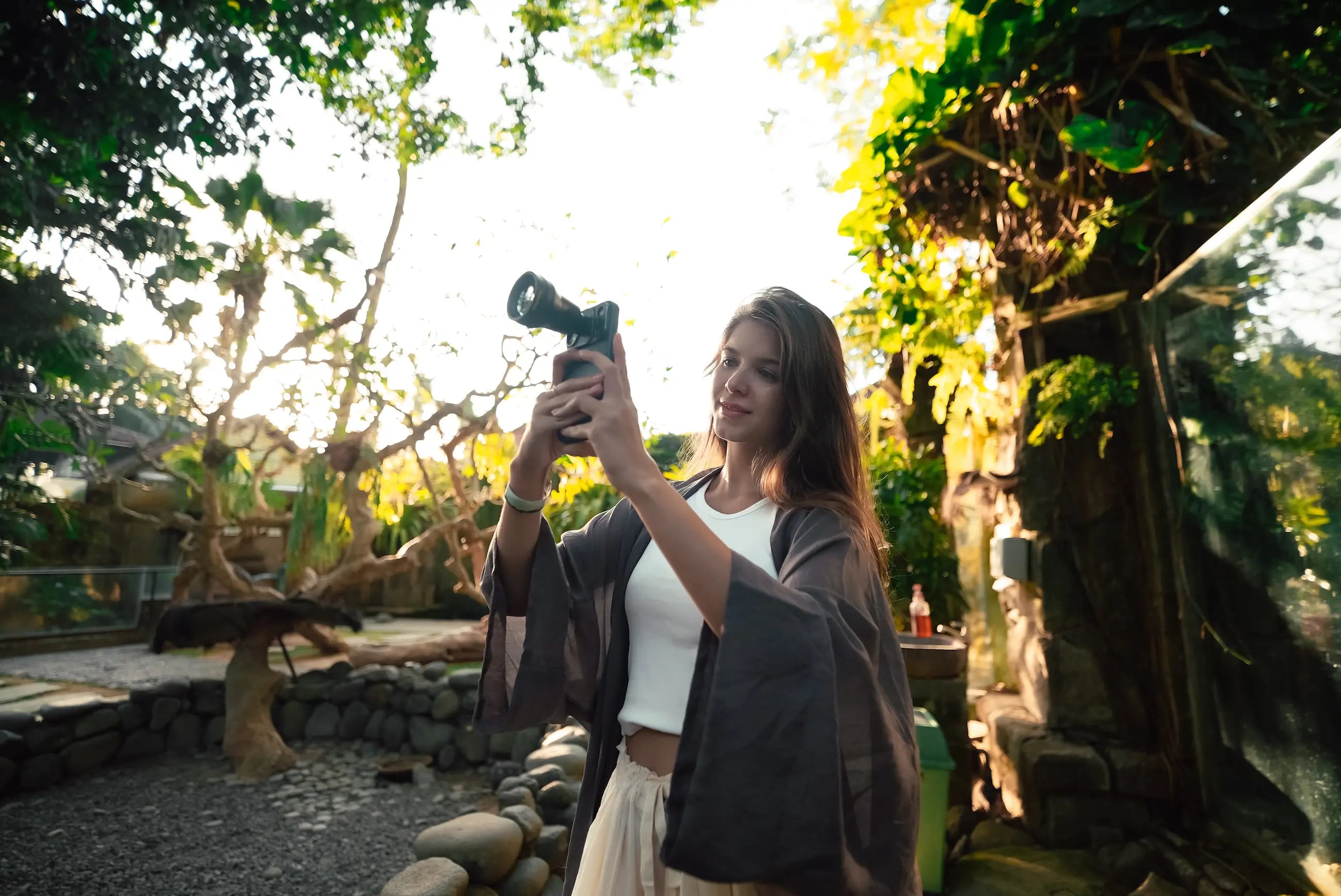 Creator using the Freewell 3x telephoto lens on a smartphone
