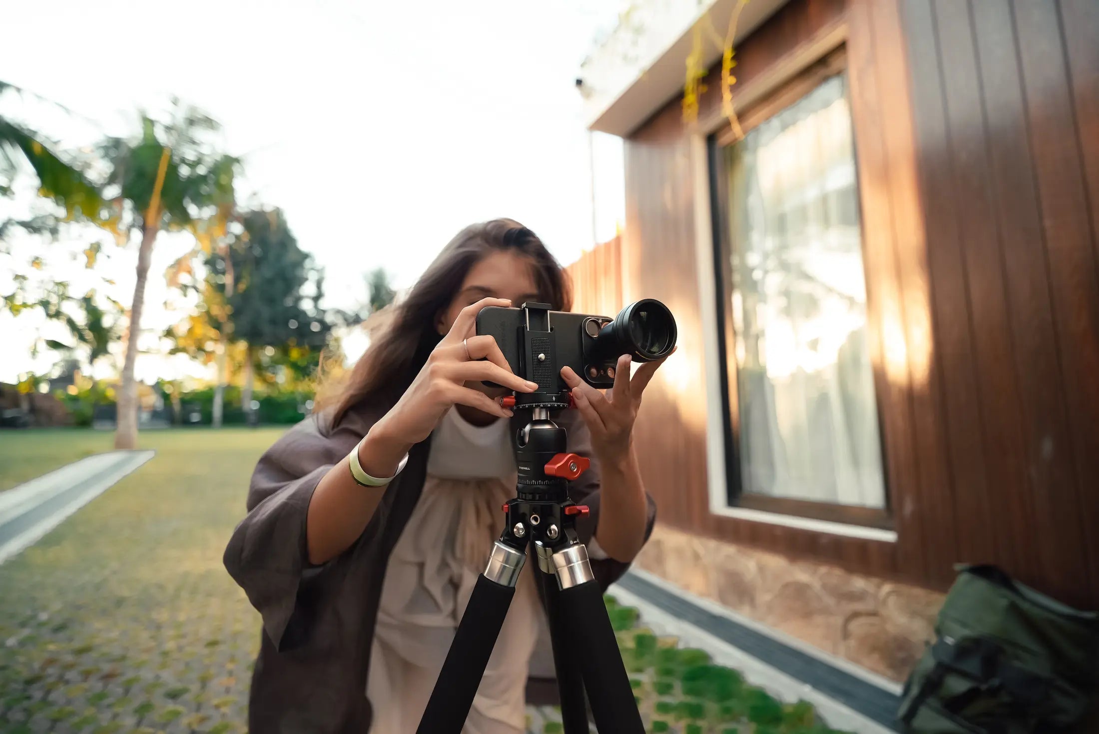 Smartphone telephoto lens supported on a tripod