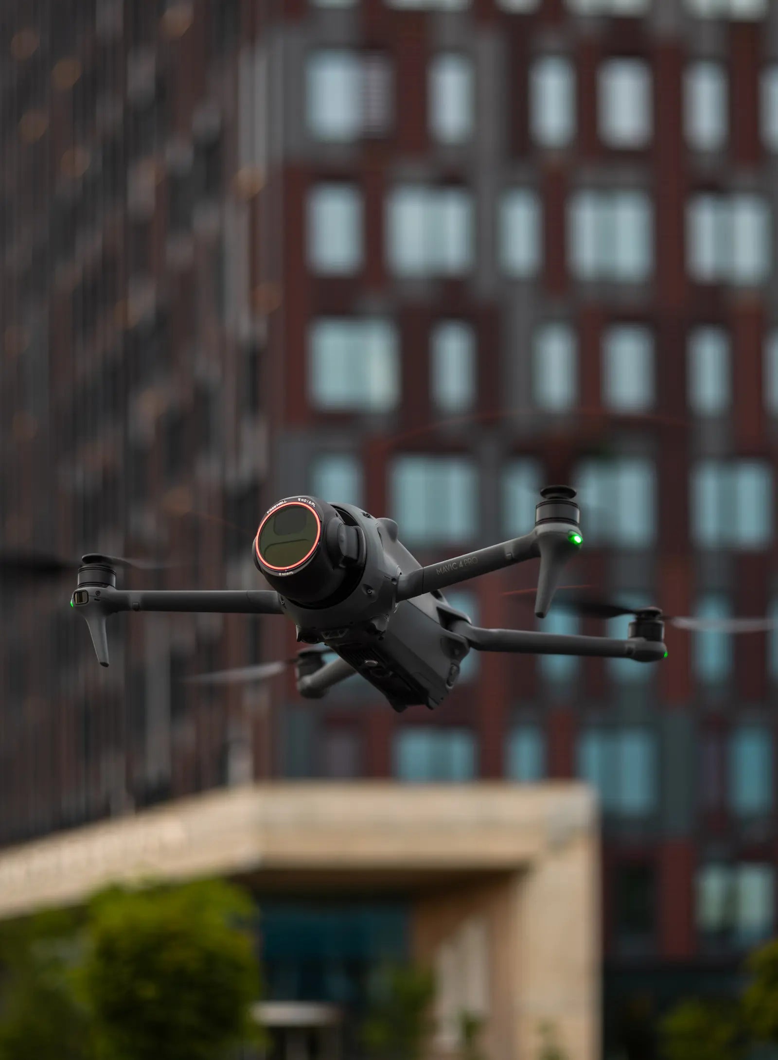 DJI Mavic 4 Pro flying with a Freewell filter mounted