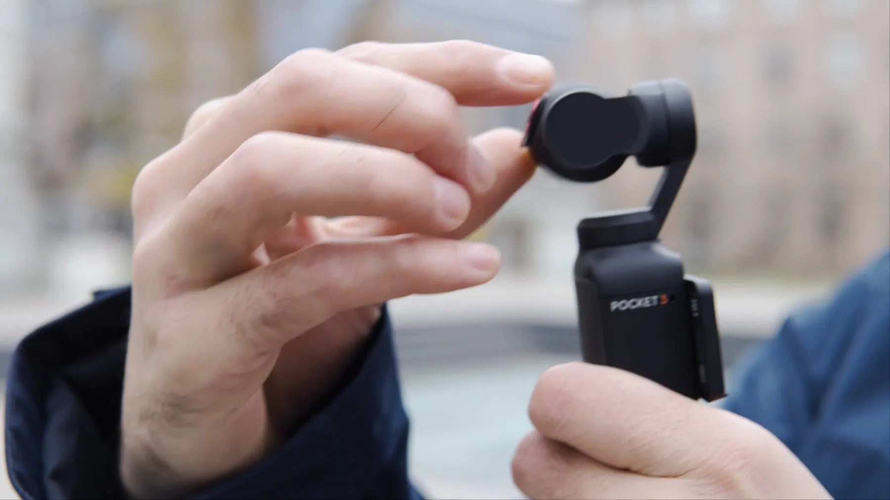 A creator placing a magnetic Freewell filter on an Osmo Pocket camera