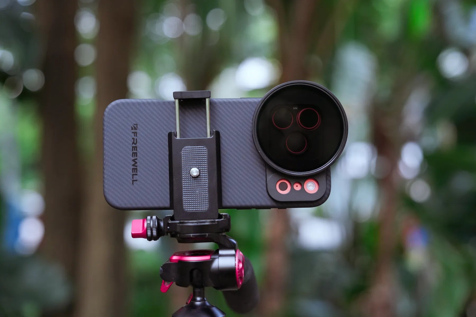 iPhone with a Freewell case, Quick Snap filter, and tripod setup outdoors