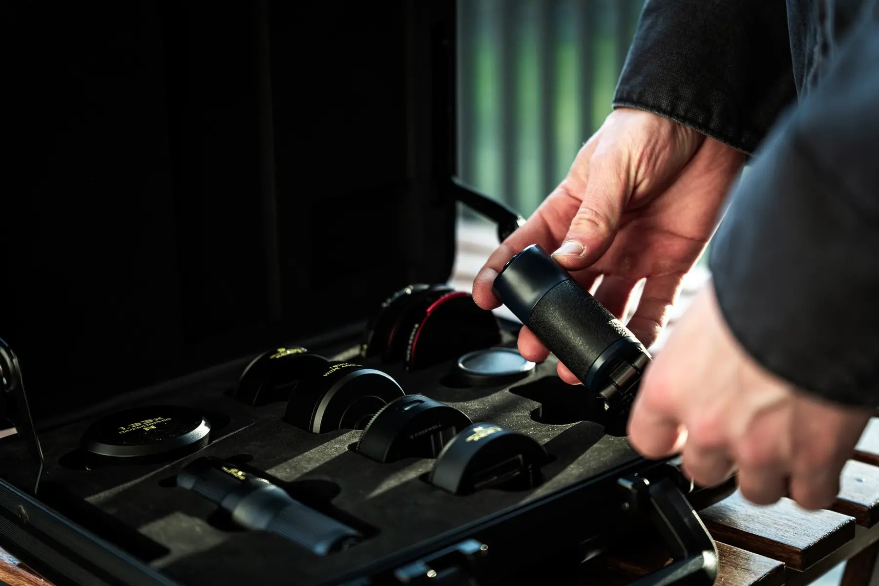 Filmmaker lifting a lens from its fitted case compartment