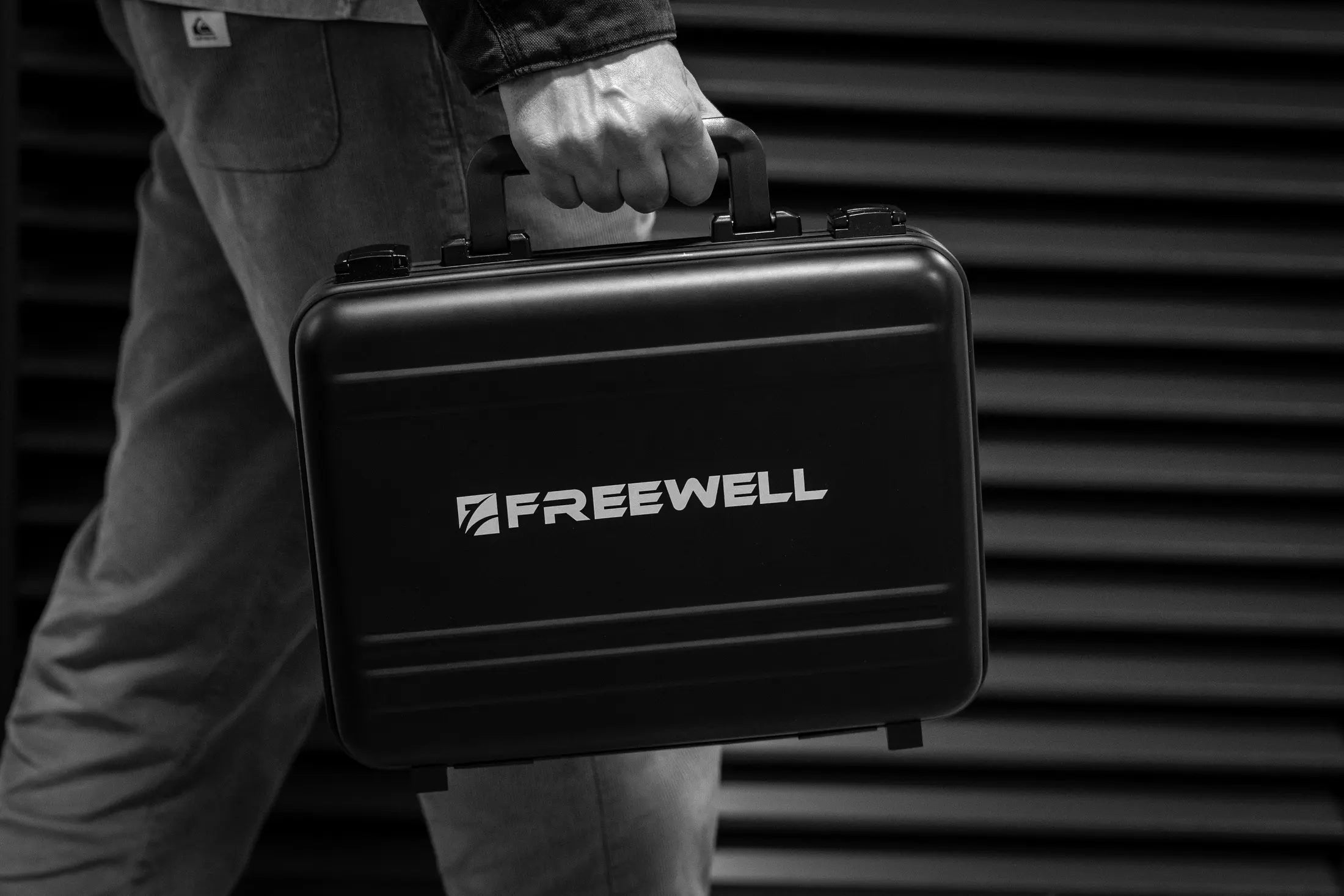 Freewell Pro Filmmaker Lens Carry Case held by its integrated handle