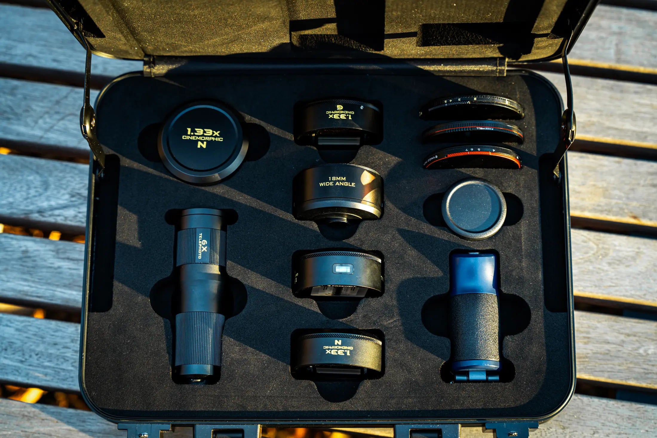 Open Freewell lens case with mobile filmmaking lenses, filters, and grip arranged in dedicated compartments