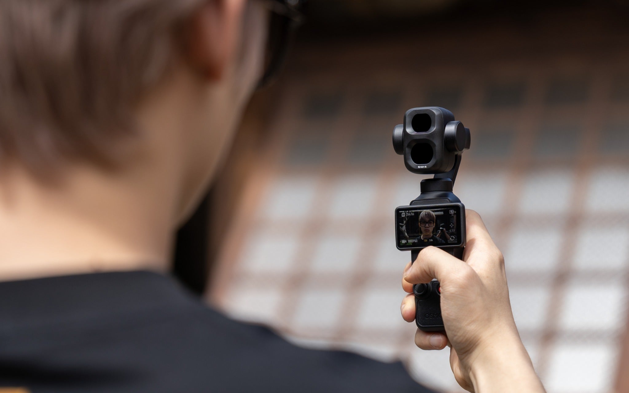 Creator filming outdoors with DJI Osmo Pocket 4P and a Freewell filter
