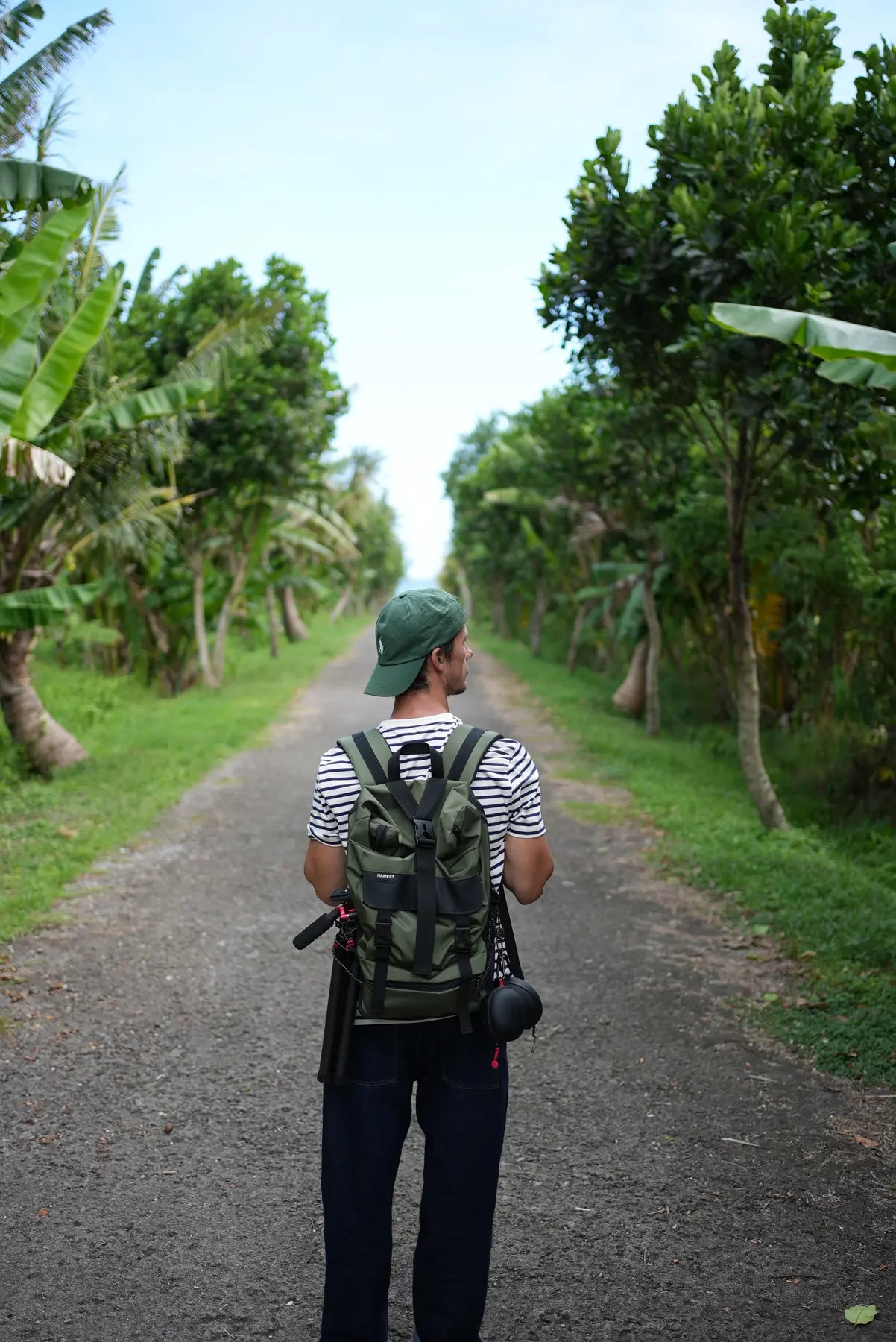 Creator carrying the compact Freewell T1 on a travel backpack