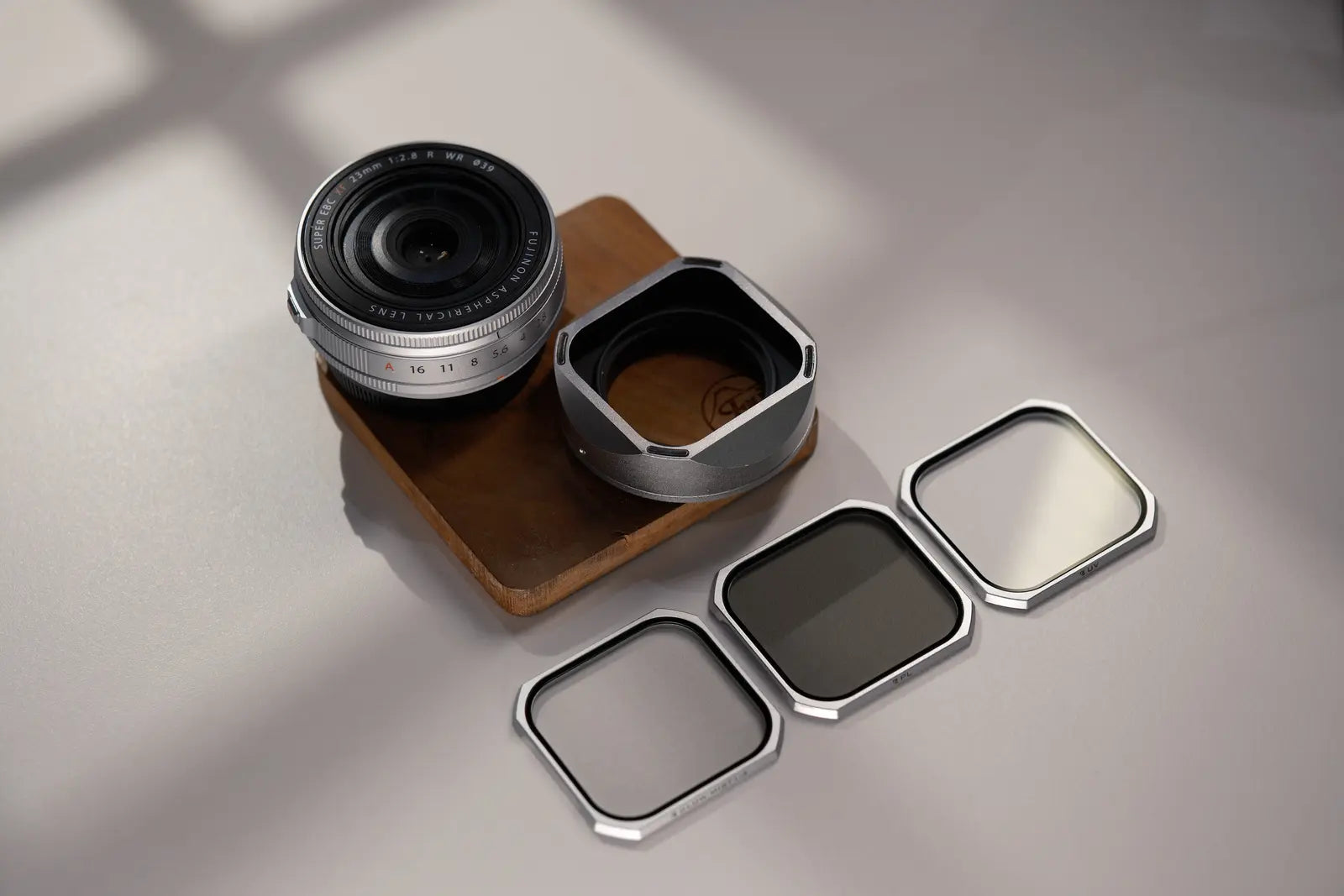 XF23mmF2.8 lens hood and three magnetic filters arranged in studio light
