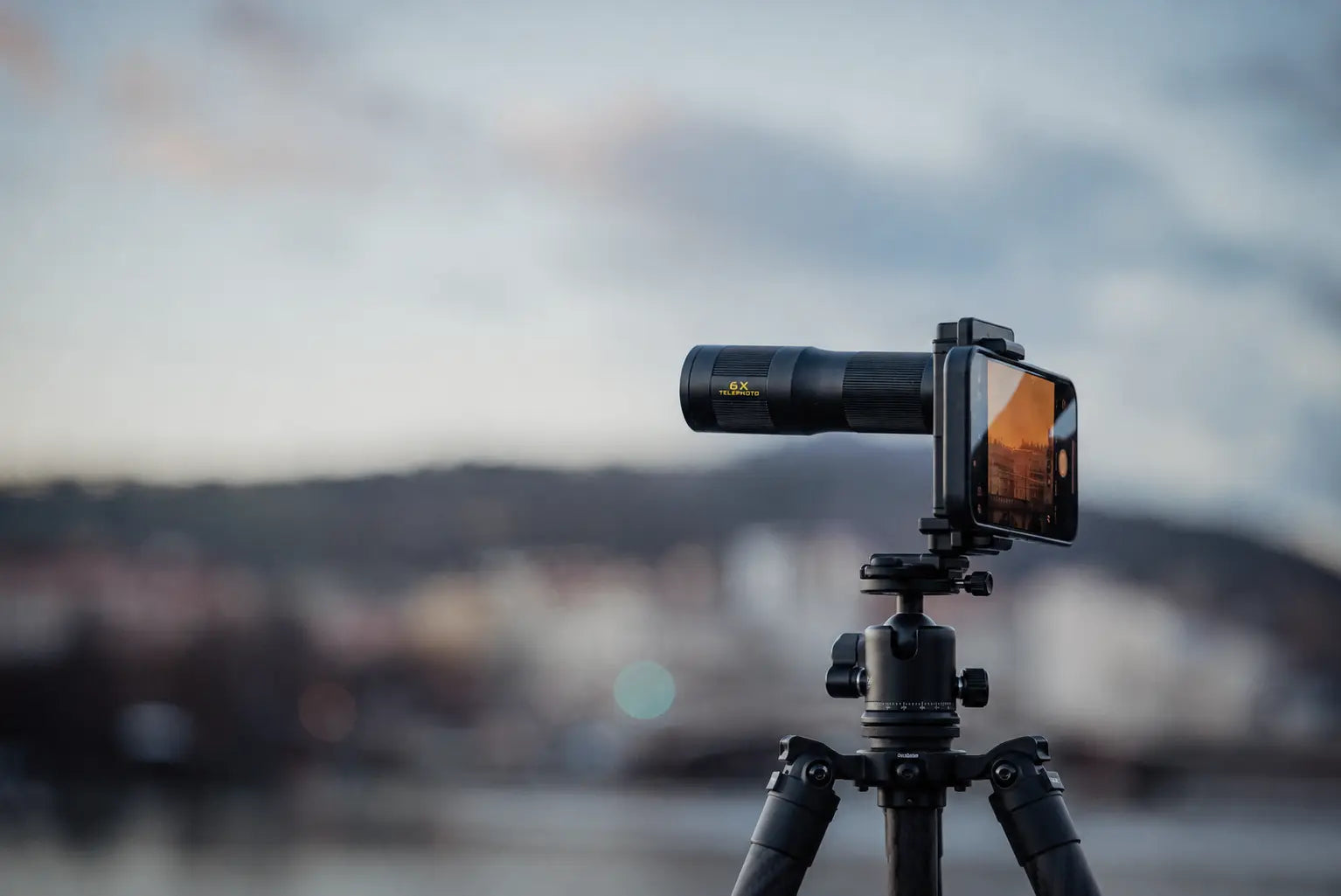 Freewell 6X Telephoto Lens securely mounted on a smartphone tripod