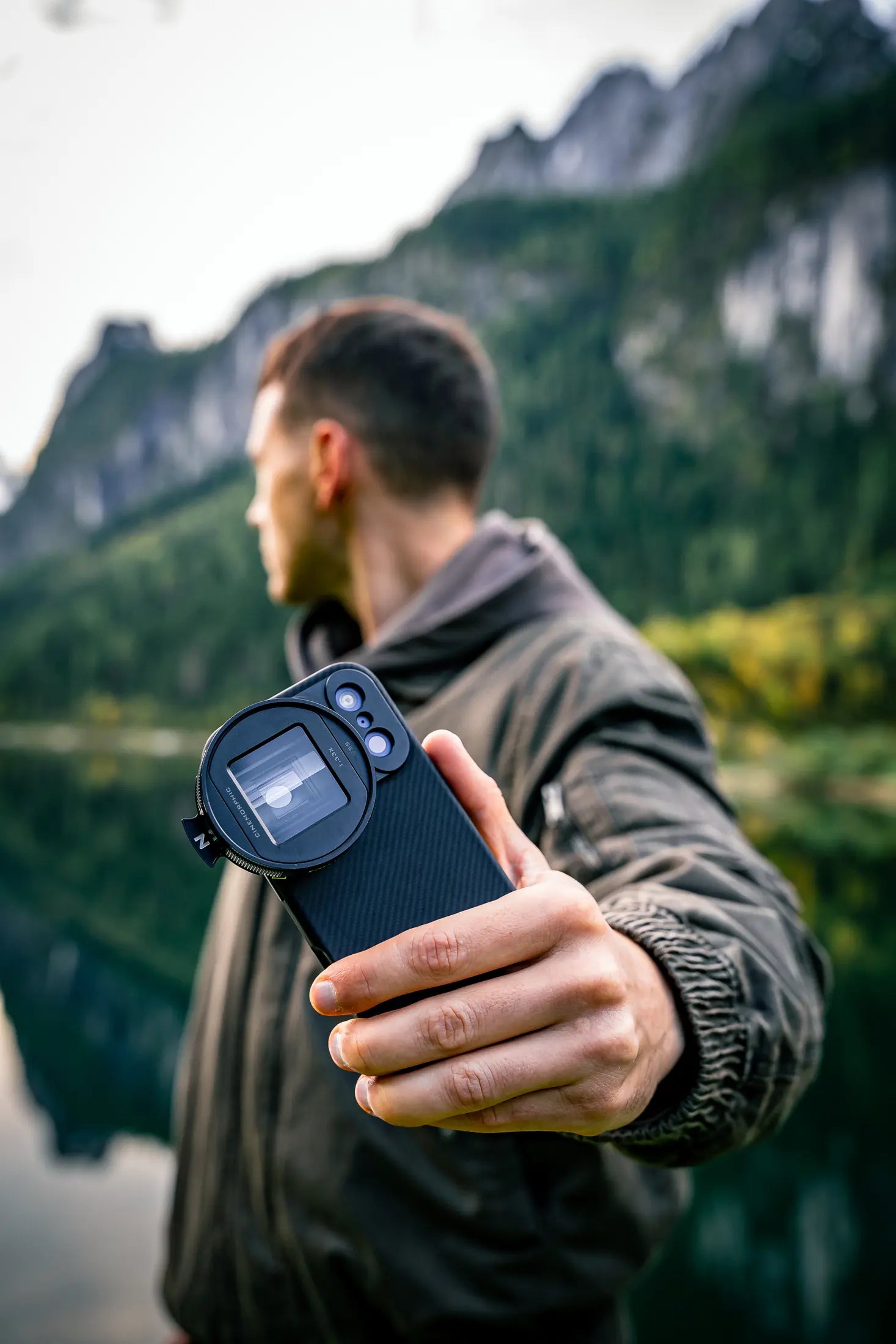 Filmmaker holding an iPhone fitted with a Freewell lens