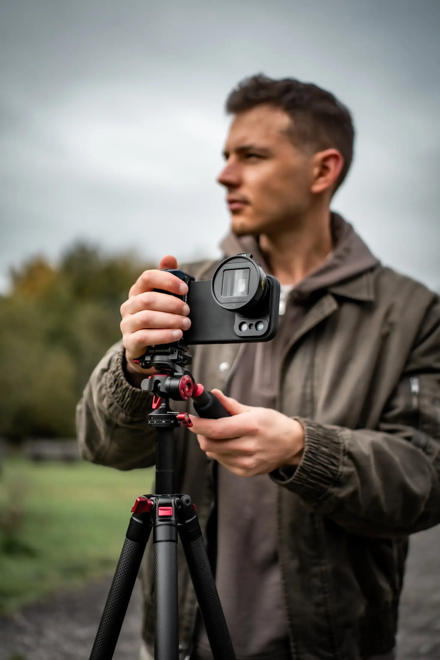 Filmmaker setting up an iPhone on a compact tripod